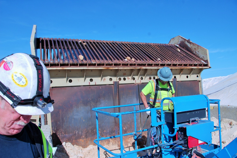 Crew installing heated grizzlies on a bin.