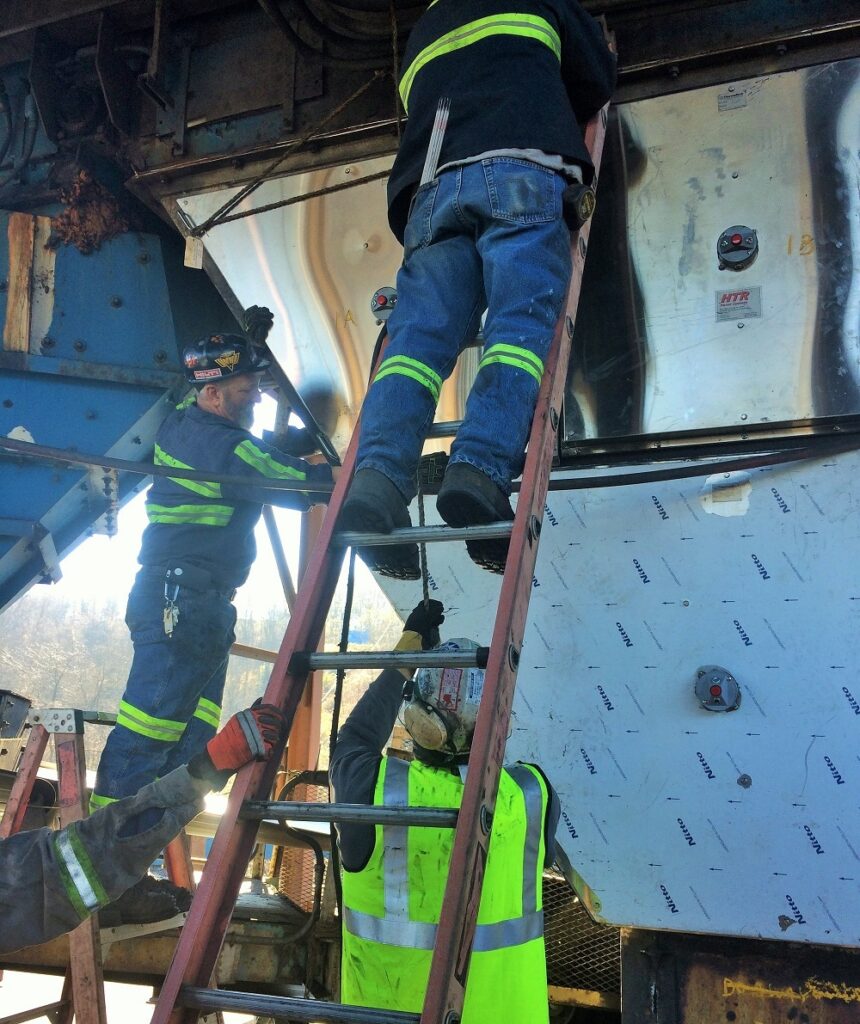 Two man crew installing a custom HTR™ Heater Panel.